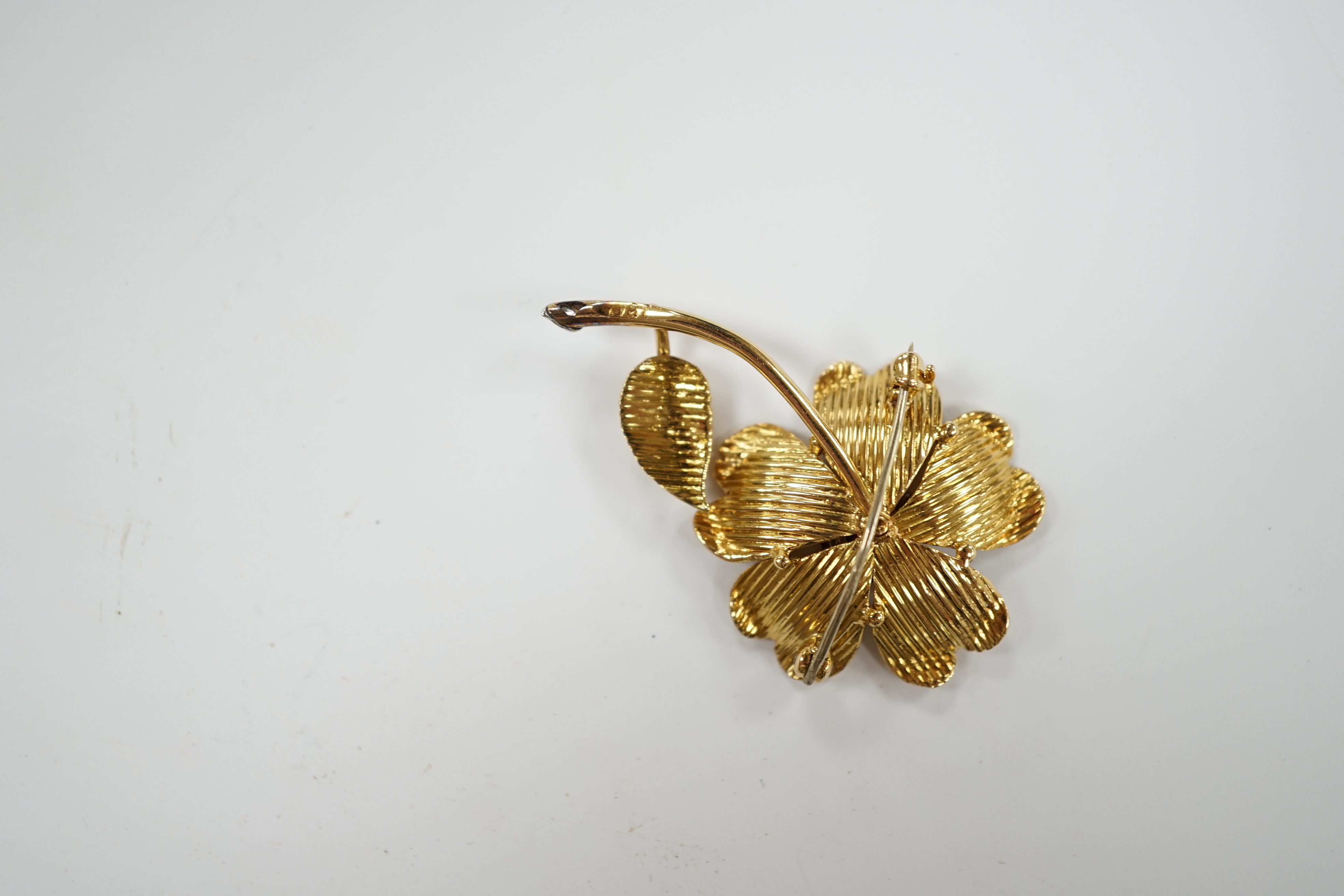 An 18ct, ruby and diamond cluster set flower brooch, 35mm, gross weight 6.3 grams.